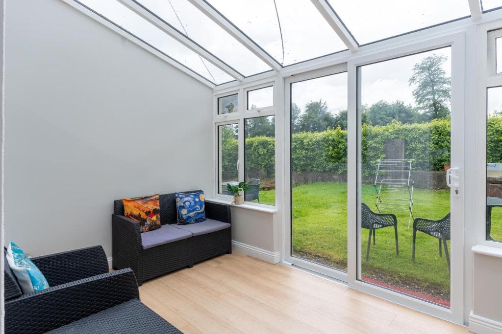 Bright conservatory with garden views at Tully's Home