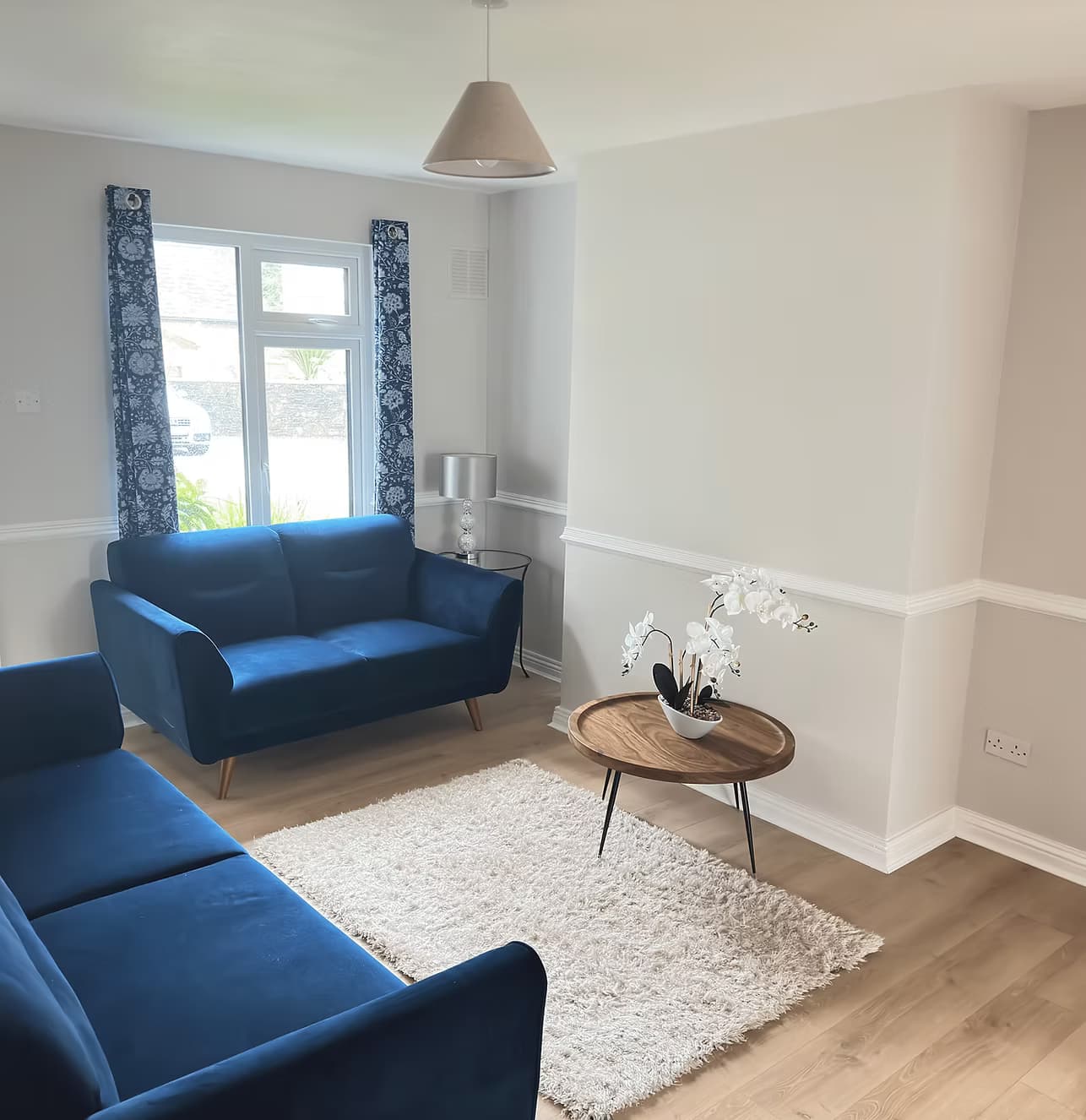 Bright blue sitting room at Tully's Home
